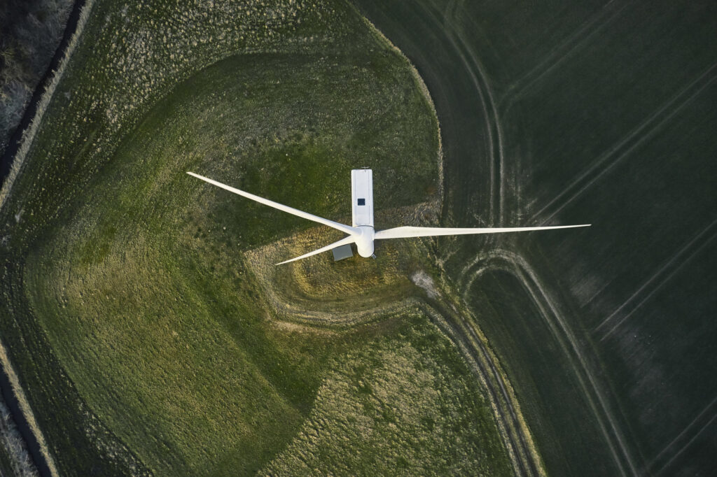 Night scene with wind mills. Wind turbines generating renewable energy. Aerial shot