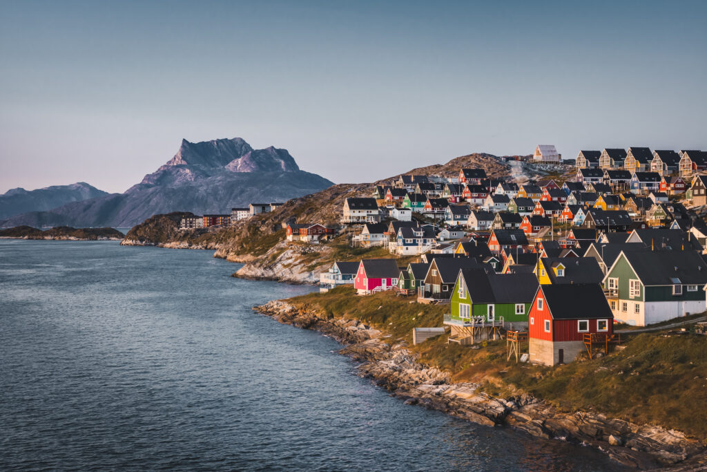 Nuuk capital of Greenland with Beautiful small colorful houses in myggedalen during Sunset Sunrise Midnight Sun. Sermitsiaq Mountain in Background. Blue and pink Sky. Photo taken in Greenland.