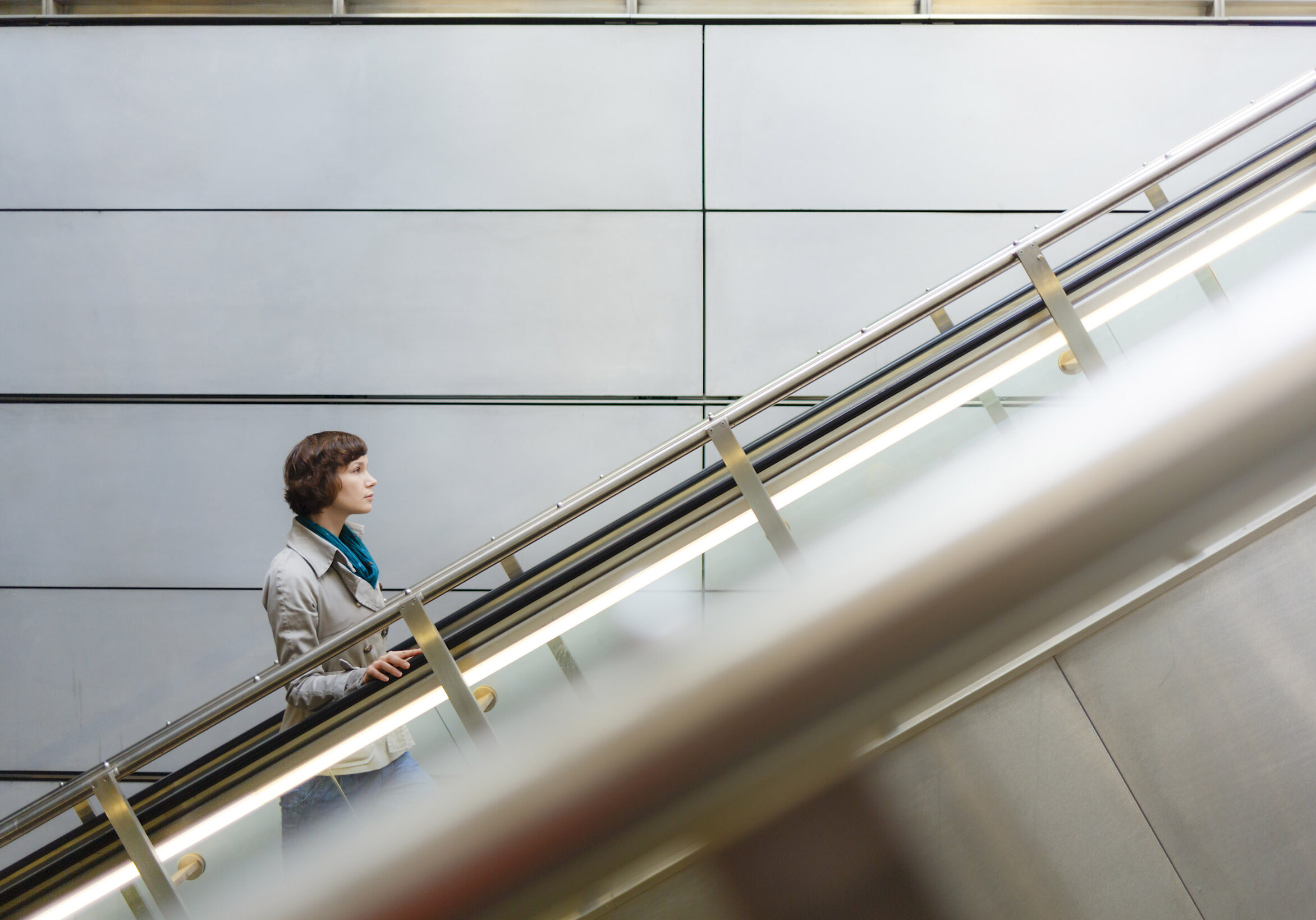 Woman on subway station escalator in Copenhagen, Denmark.